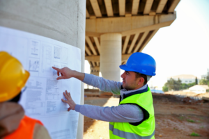 This is an image of a transportation engineer working on a highway overpass project. 